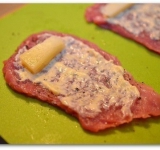 На каждый кусочек мяса положите по брусочку сыра.	