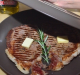 Готовое мясо перекладываем в тарелку, сверху выкладываем по 5-6 грамм сливочного масла, можно выложить пряную траву (розмарин). Накрываем блюдо другой тарелкой или фольгой на 10 минут, чтобы сок равномерно распределился по куску, и мясо стало сочным.	